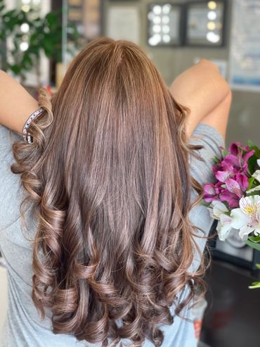 Voluminous brown hair with caramel highlights